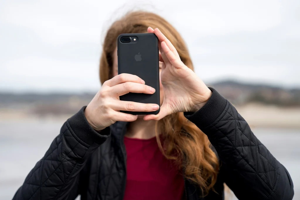 A Girl is holding his free iphone.